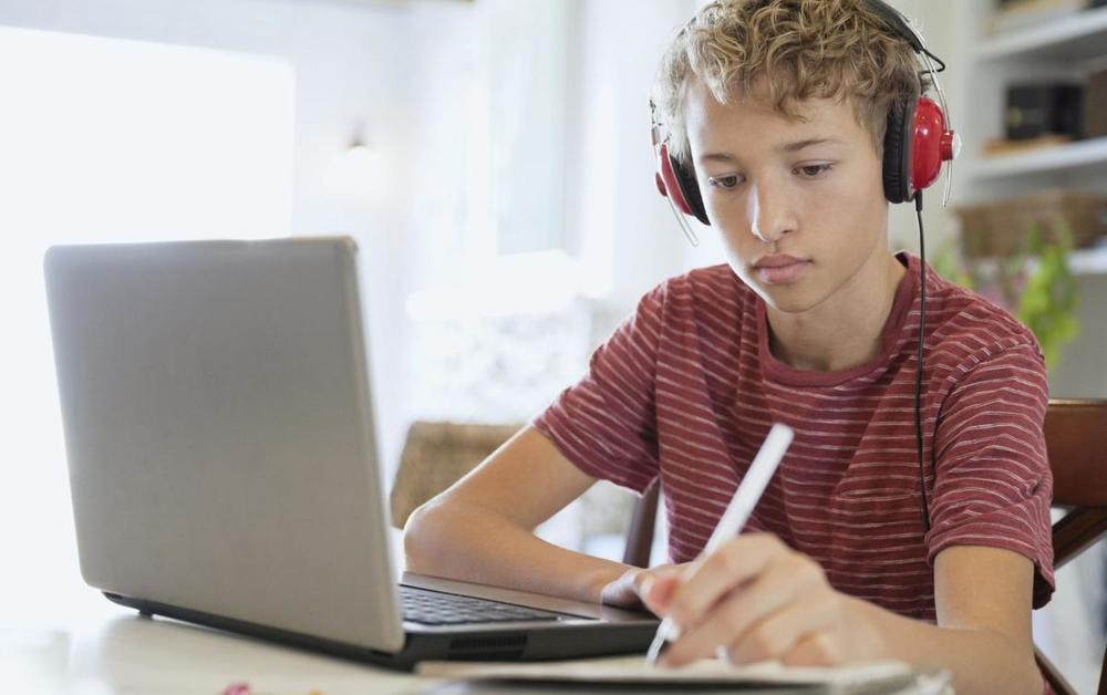Student on computer at home virtual school