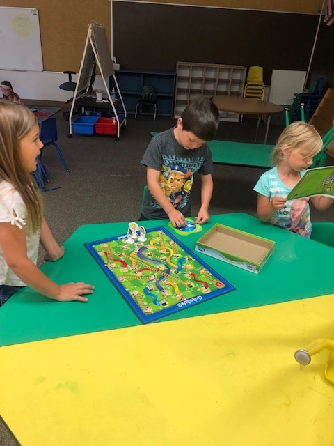 Summer school students playing chutes and ladders