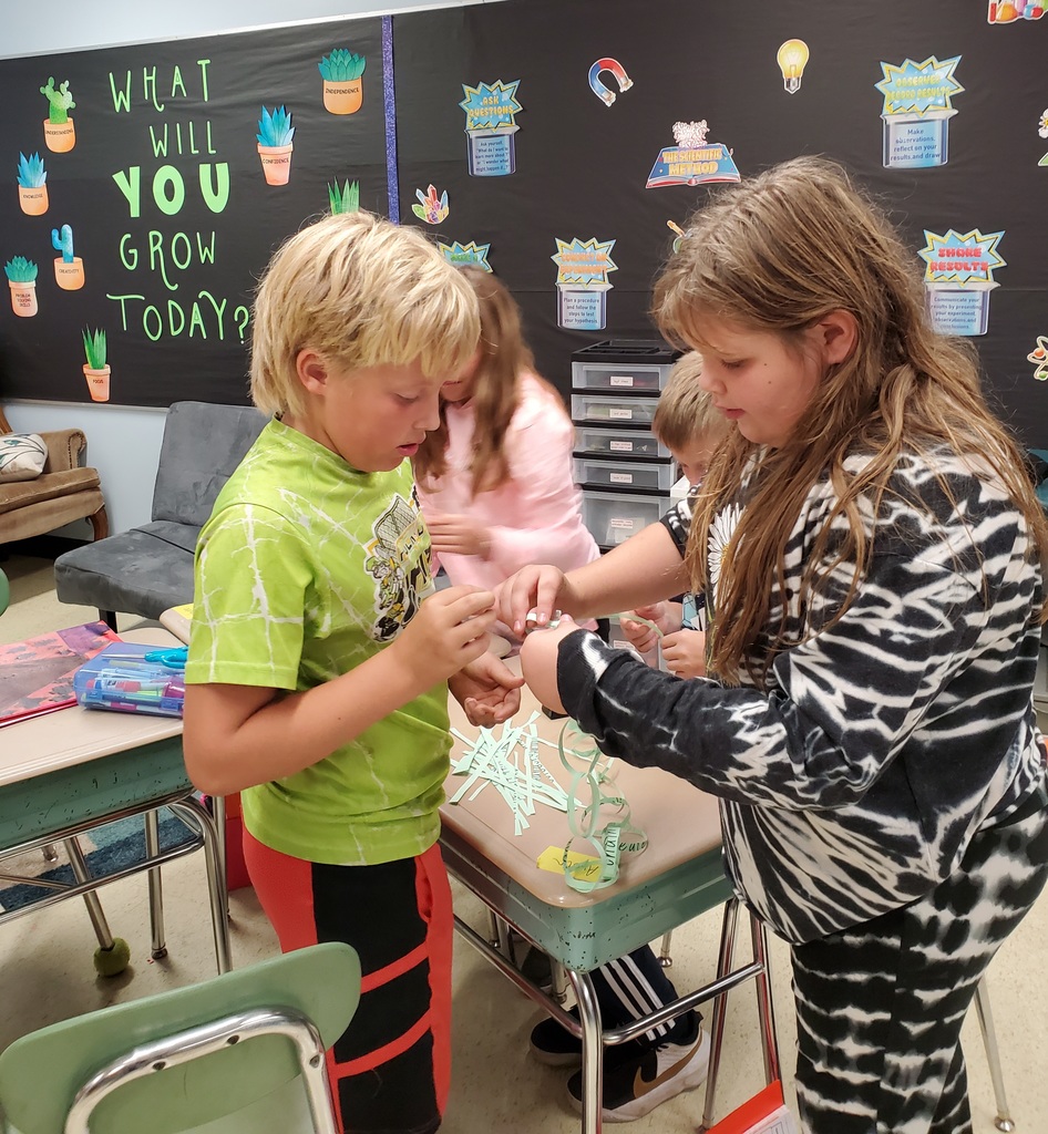 Paper chain engineering - students helping each other make the paper chains
