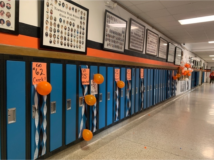 hallway of lockers with balloons for the football players