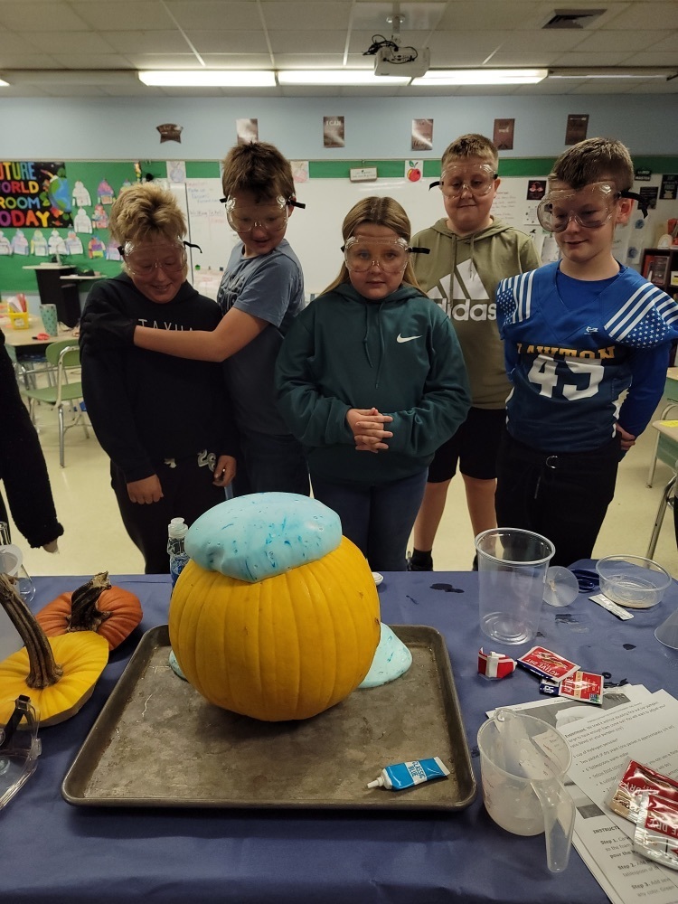 students watching foam coming out of a pumpkin