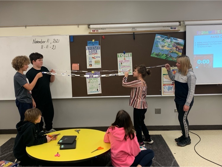 students comparing a paper chain 