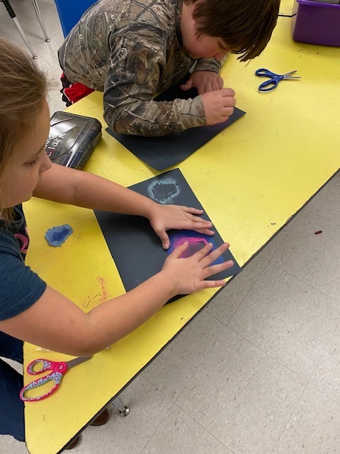 Two students working on art project