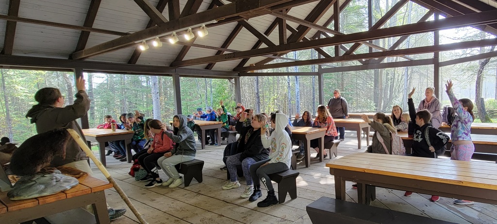 students outside with presenter