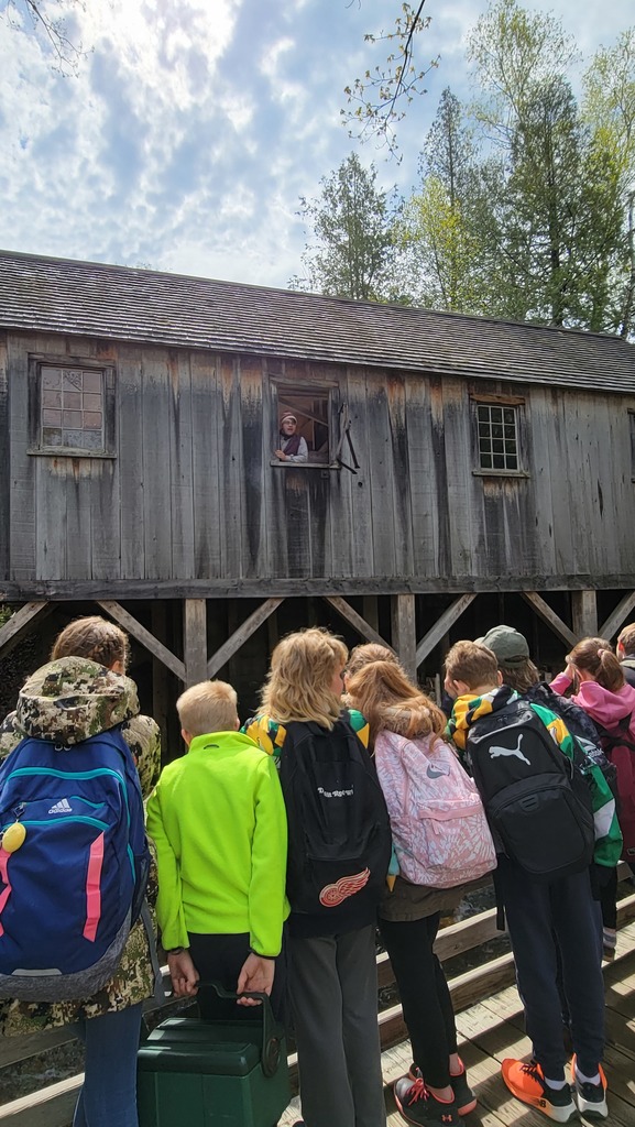 students gathered looking at a old mill
